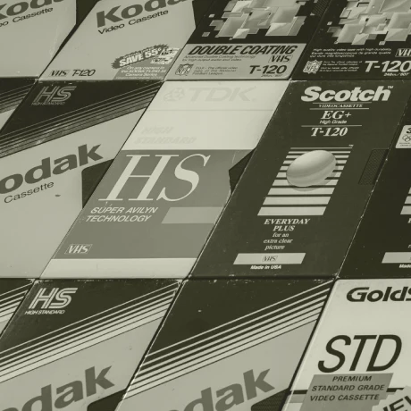 Monochrome photo of VHS sleeves.
